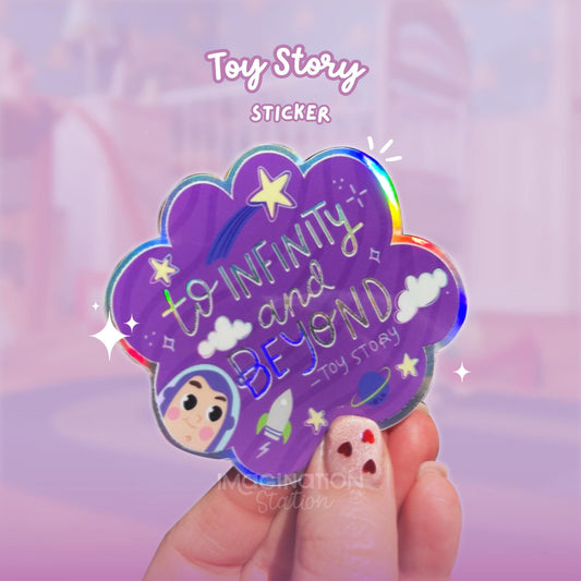 Toy Story sticker with 'To Infinity and Beyond' text held by a hand against a blurred background.