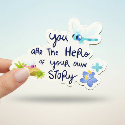 Sticker with text 'you are the hero of your own story' and cartoon character, with 'Bluey' and 'Imagination Station' branding.