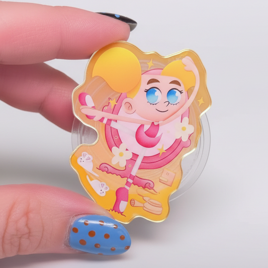 Phone holder with cartoon character design held by a hand against a colorful background