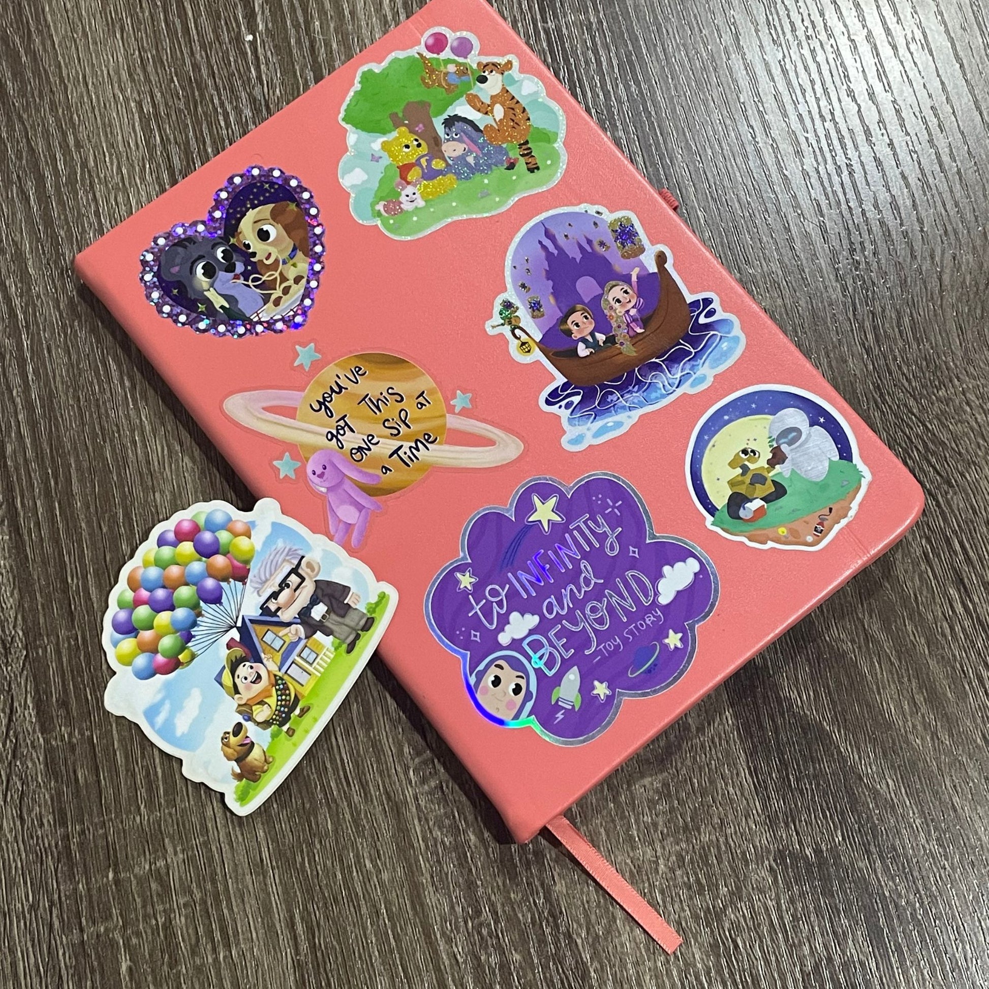 Adventure Is Out There Up sticker held by hand – matte waterproof Disney Pixar vinyl decal
