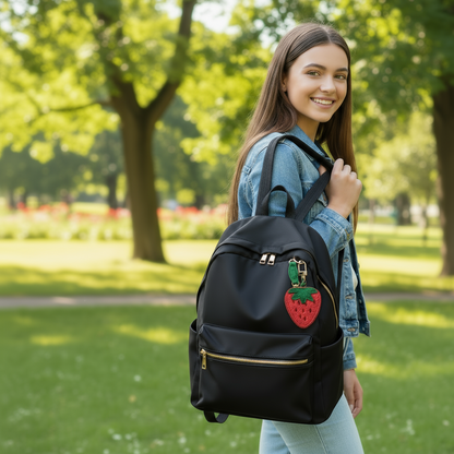Strawberry-shaped keychain with green leaves on a colorful background