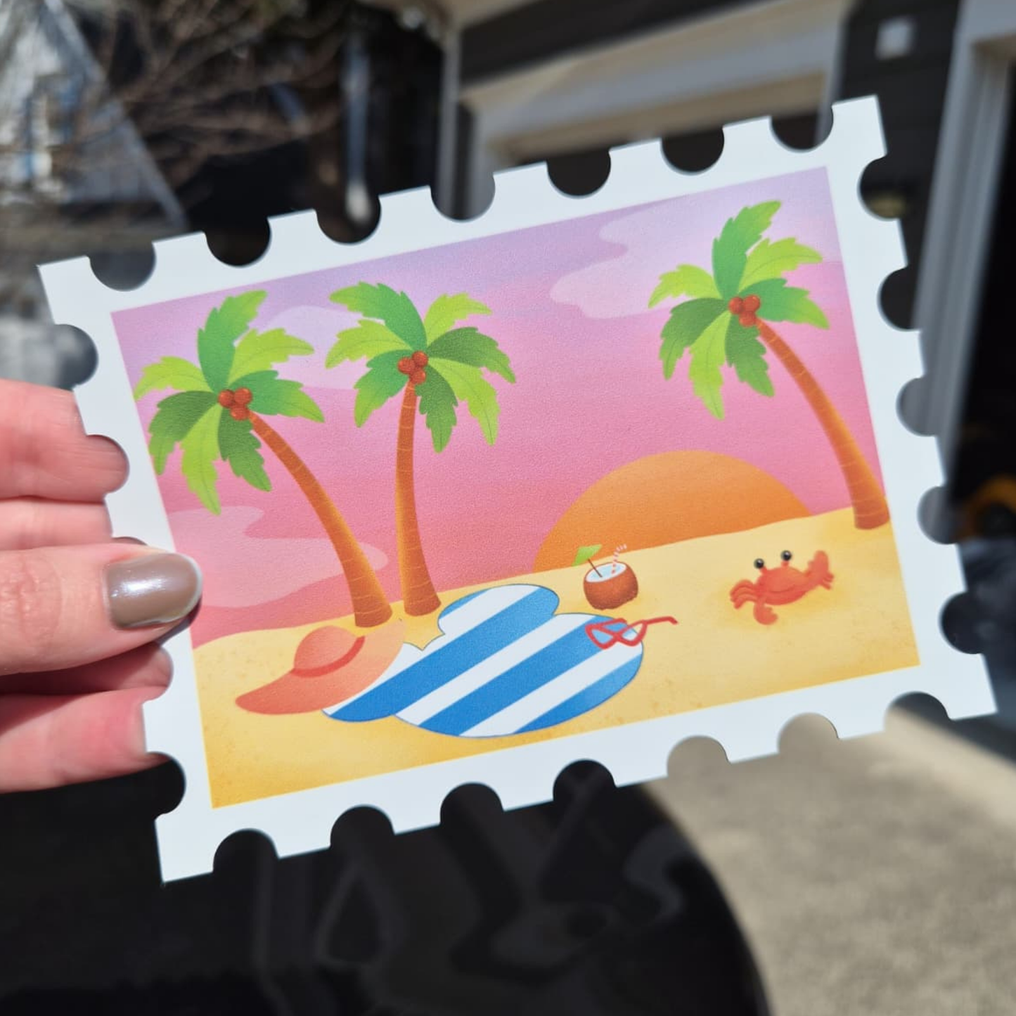 A close-up of a custom die-cut Disney cruise stateroom door magnet shaped like a postage stamp. The design shows a tropical beach sunset with palm trees and a Mickey Mouse silhouette beach towel.