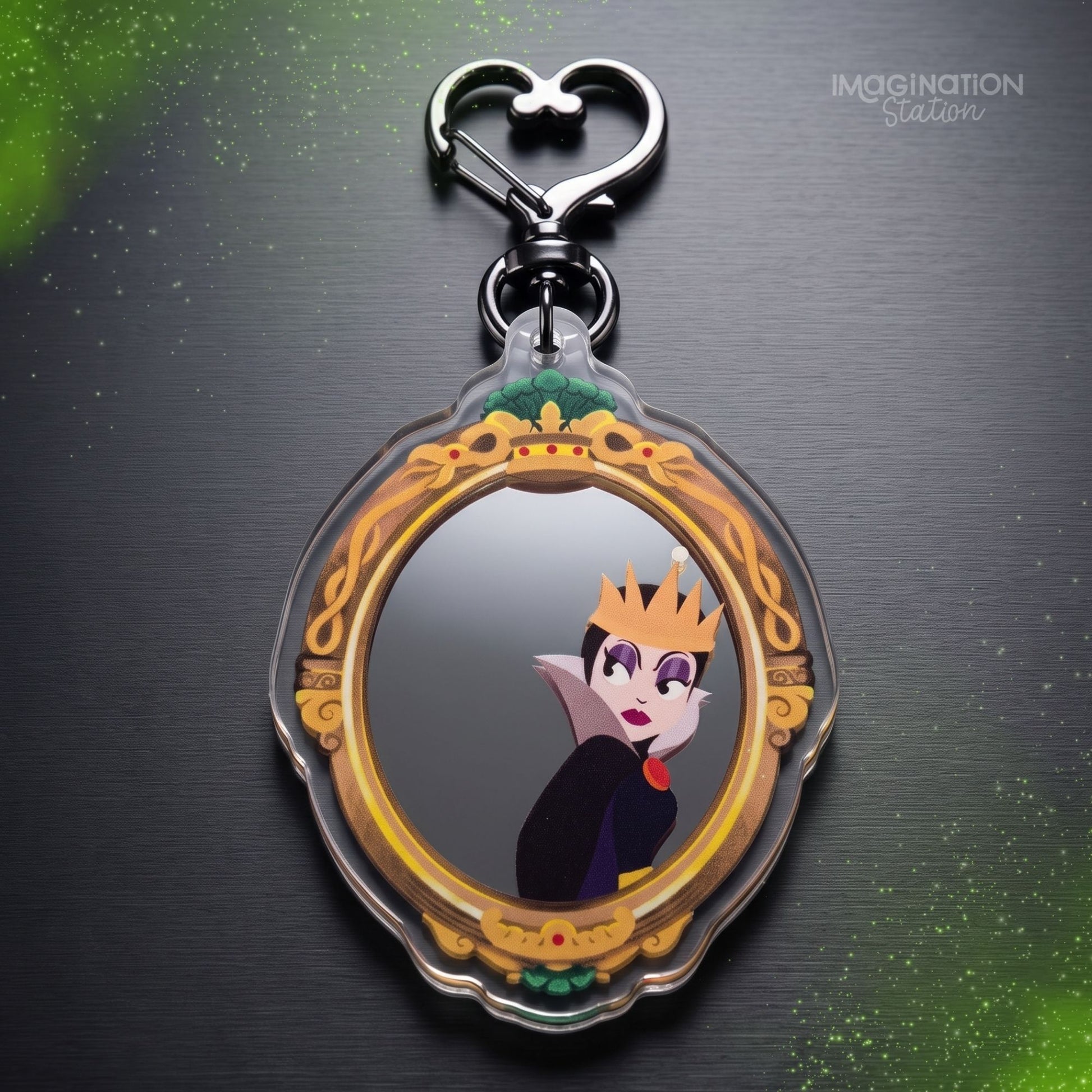 Wicked Queen mirror bag charm held in hand, showing gold ornate frame and mirror-finish acrylic