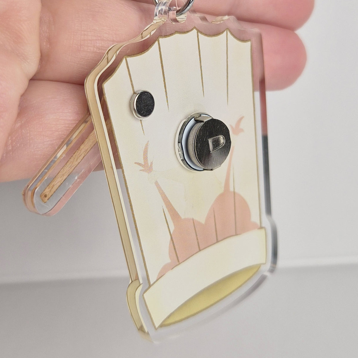 Ratatouille Remy keychain size reference showing 3 inch acrylic chef hat charm
