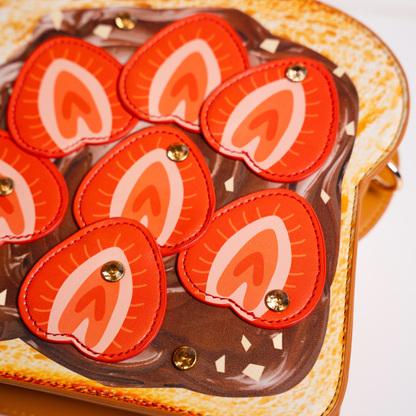 Strawberry Nutella toast bag lifestyle shot held in hand with oven mitt