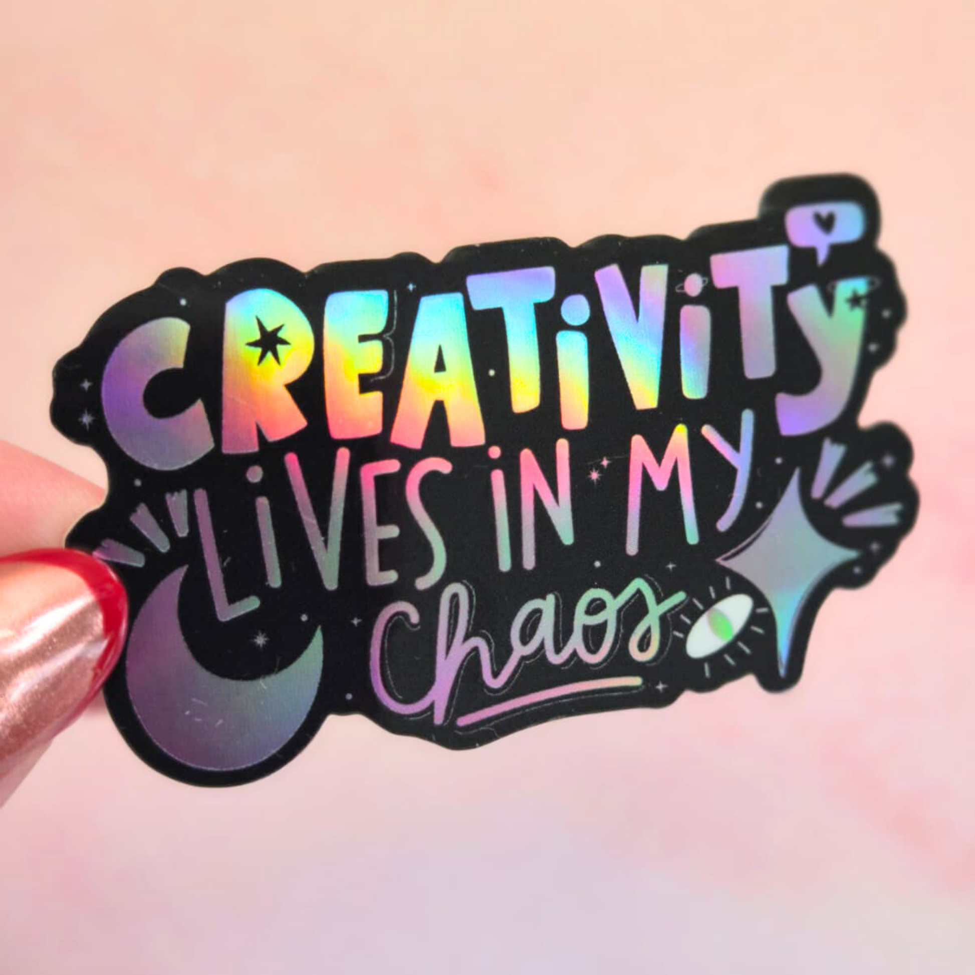 Creativity Lives in My Chaos holographic sticker held by hand – waterproof rainbow vinyl decal