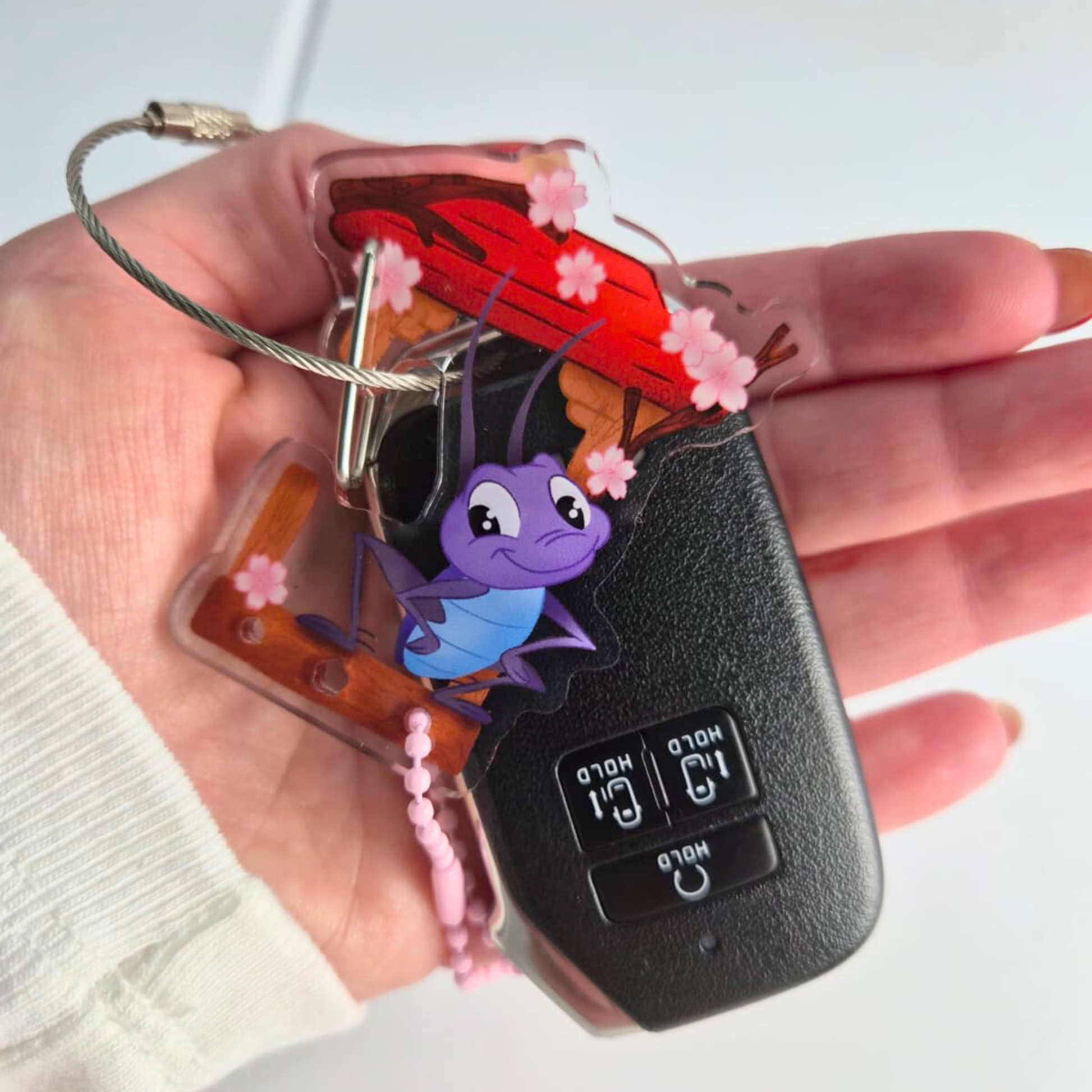 Mulan Cri-kee keychain clipped to bag – Disney lucky cricket functional clip charm