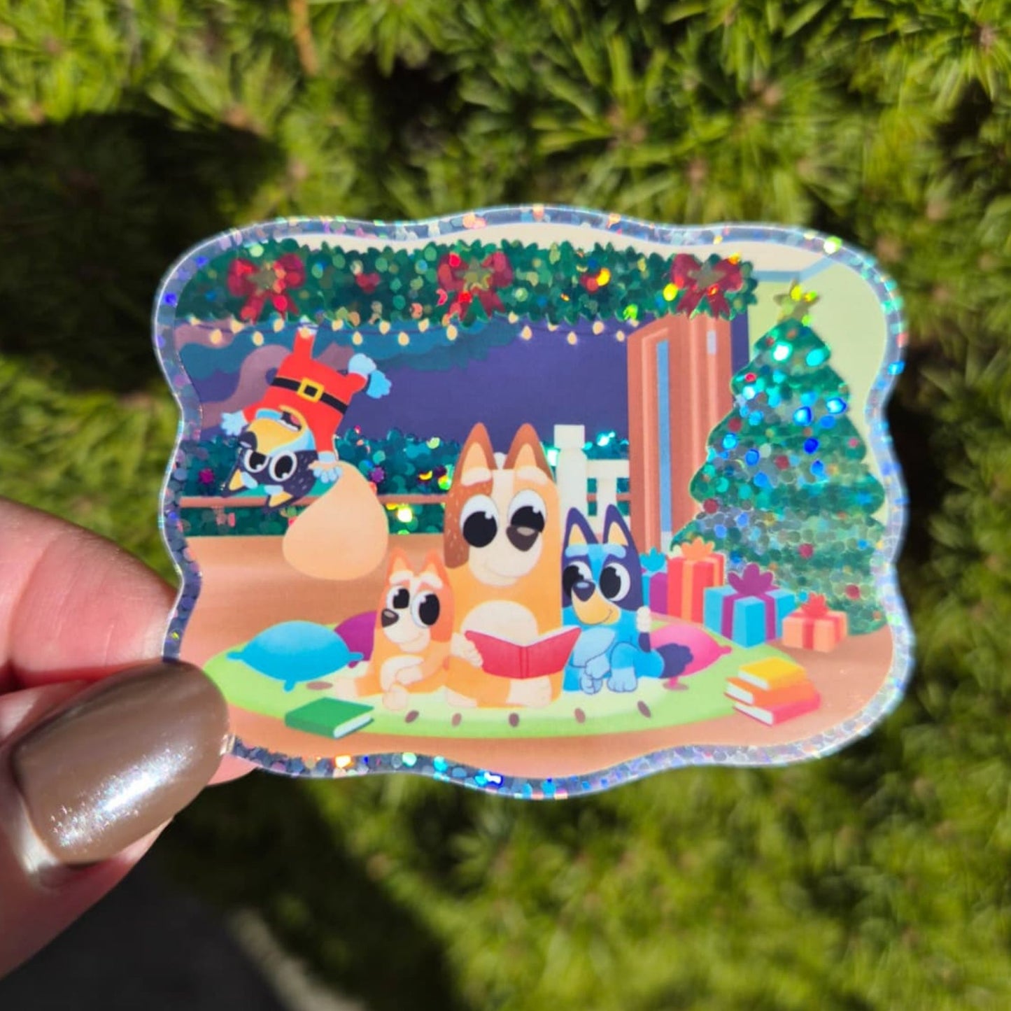 Colorful sticker with cartoon characters in a festive scene held against a green background