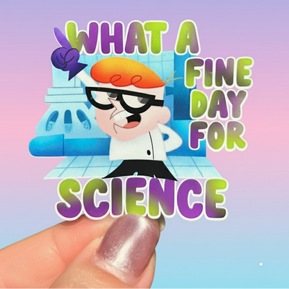 Sticker with cartoon character and text 'What a fine day for science' held against a green leafy background