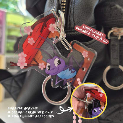 Keychain with cartoon characters attached to a bag, featuring text on durability and design.