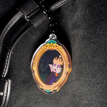 Close-up of Wicked Queen mirror bag charm showing the villain queen illustration inside the frame