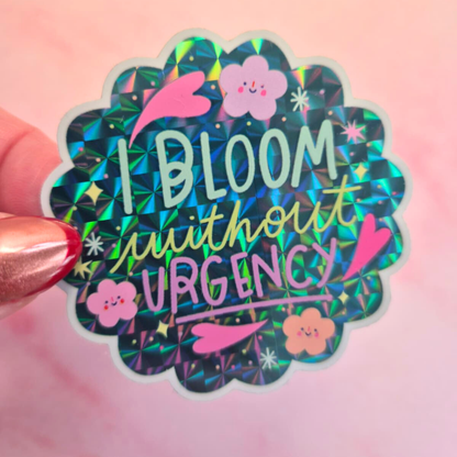 I Bloom Without Urgency prismatic sticker held by hand – waterproof glossy inspirational vinyl