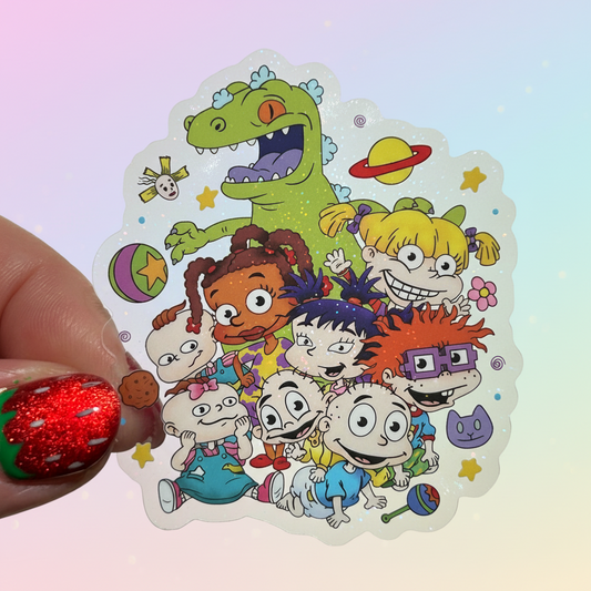 Colorful sticker with cartoon characters held by a hand with red nail polish.