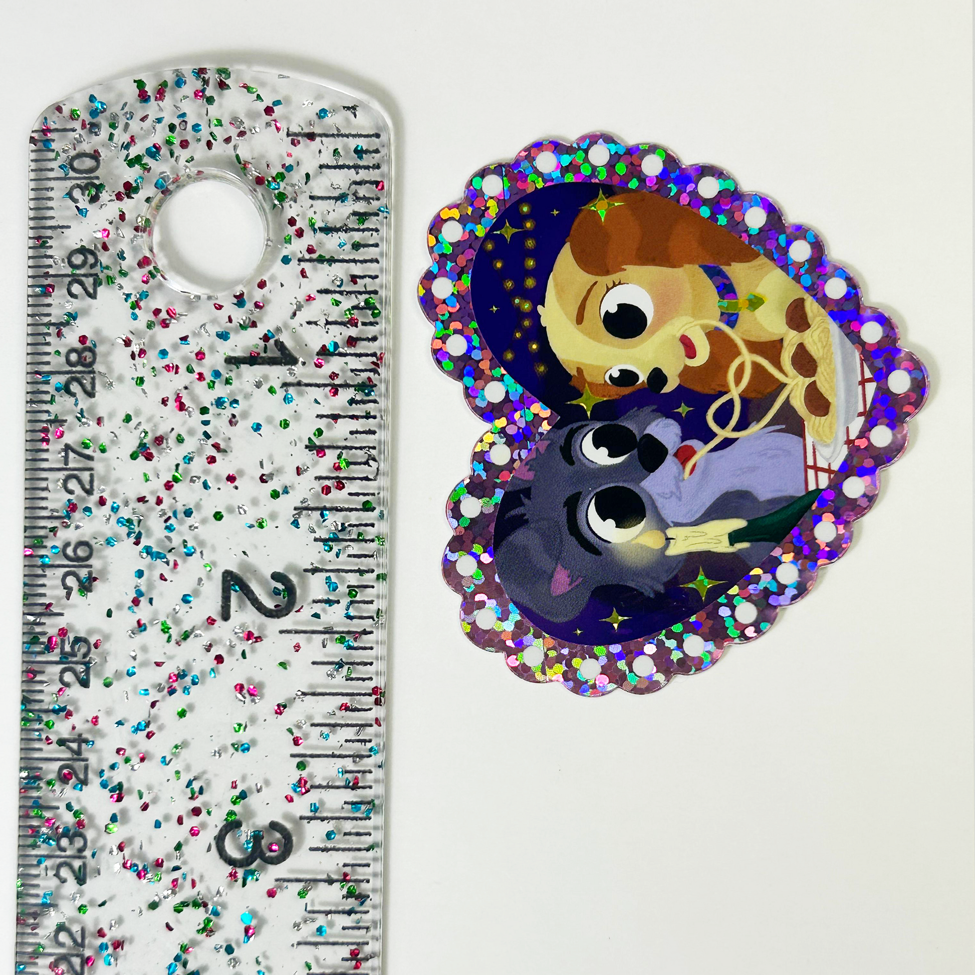 Lady and the Tramp glitter sticker held by hand – romantic Disney spaghetti scene vinyl