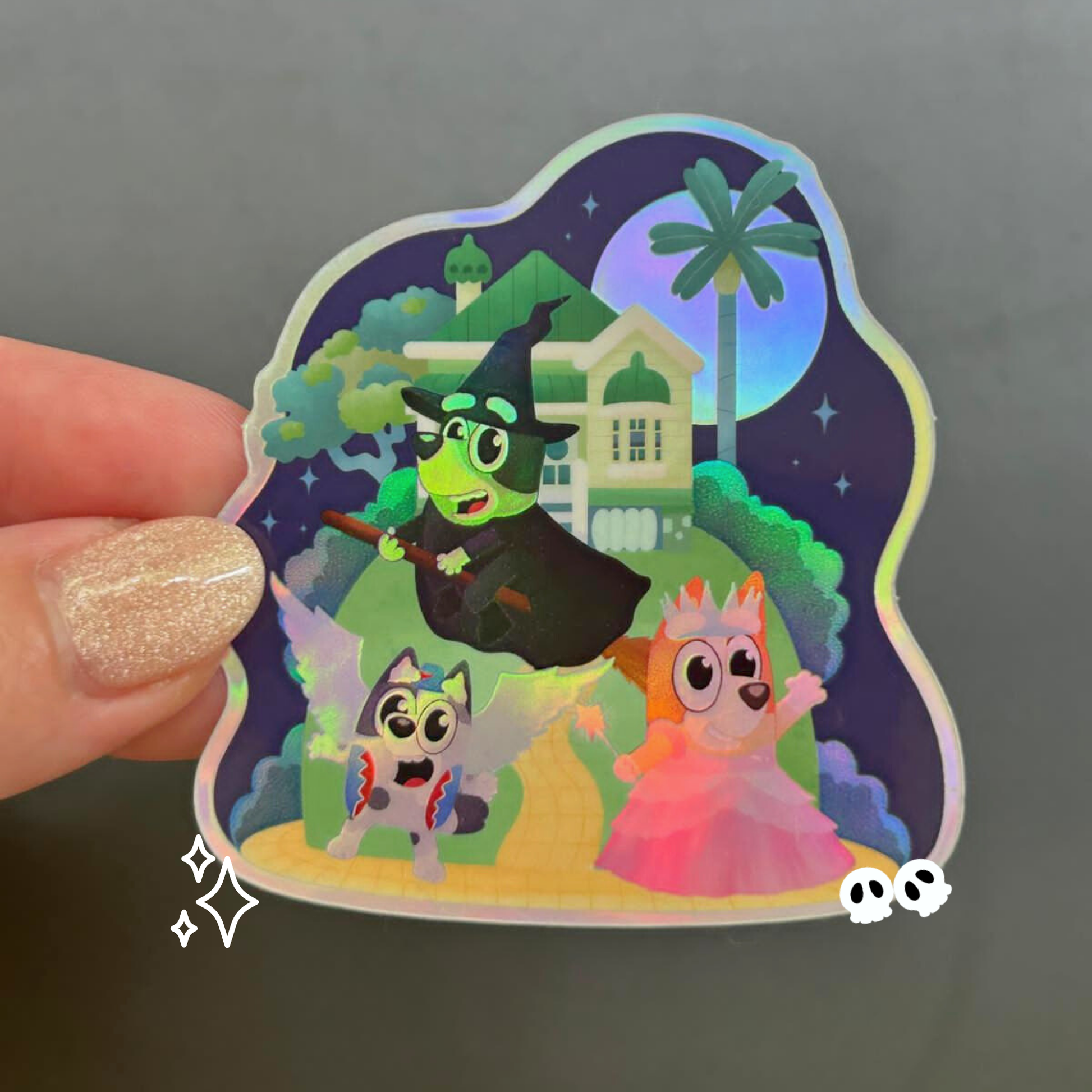 Bluey Bingo Muffin Wicked Halloween holographic sticker held by hand – Disney crossover vinyl