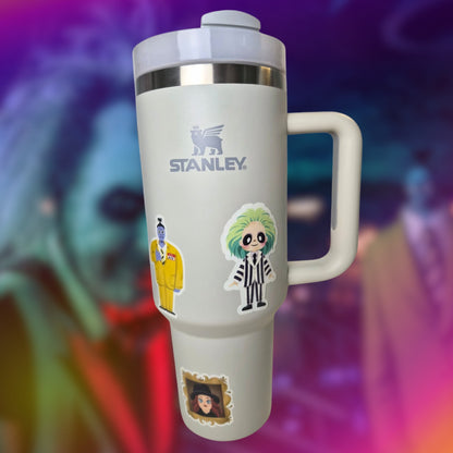 Stanley mug with cartoon character stickers on a colorful background
