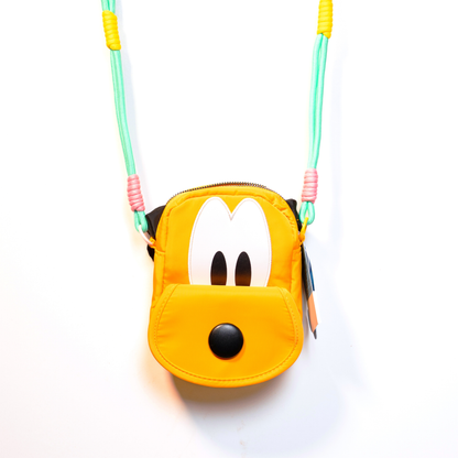 Pluto shaped handbag lifestyle shot being worn as crossbody