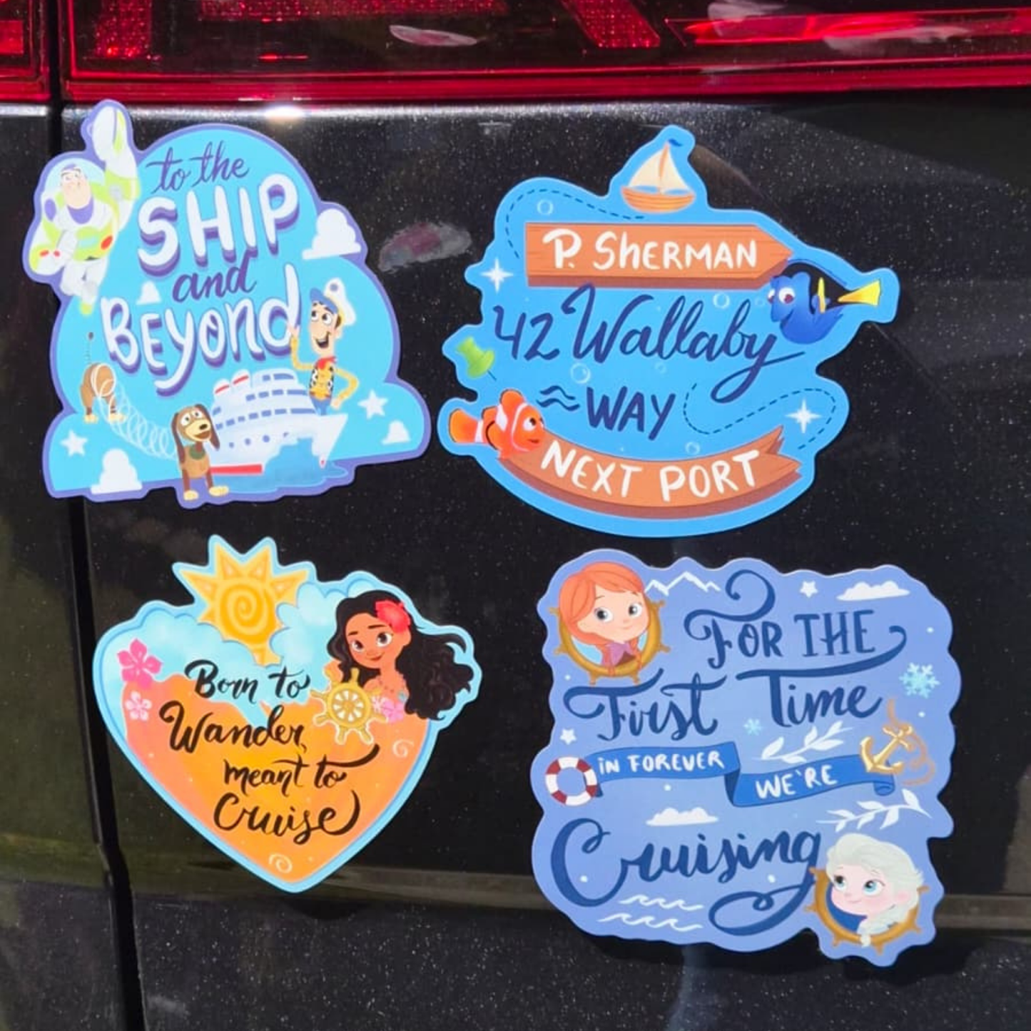 Close-up of four custom die-cut Disney-themed magnets on a black surface. Features exact text for: "To the SHIP and Beyond!", "P. SHERMAN 42 Wallaby Way NEXT PORT", "Born to Wander meant to Cruise", and "FOR THE first Time IN FOREVER WE'RE Cruising". Perfect for stateroom door decor.