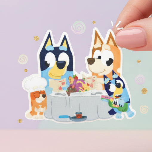Sticker design of two cartoon dogs with the text 'Bluey Sticker' and 'Imagination Station' on a blurred outdoor background.