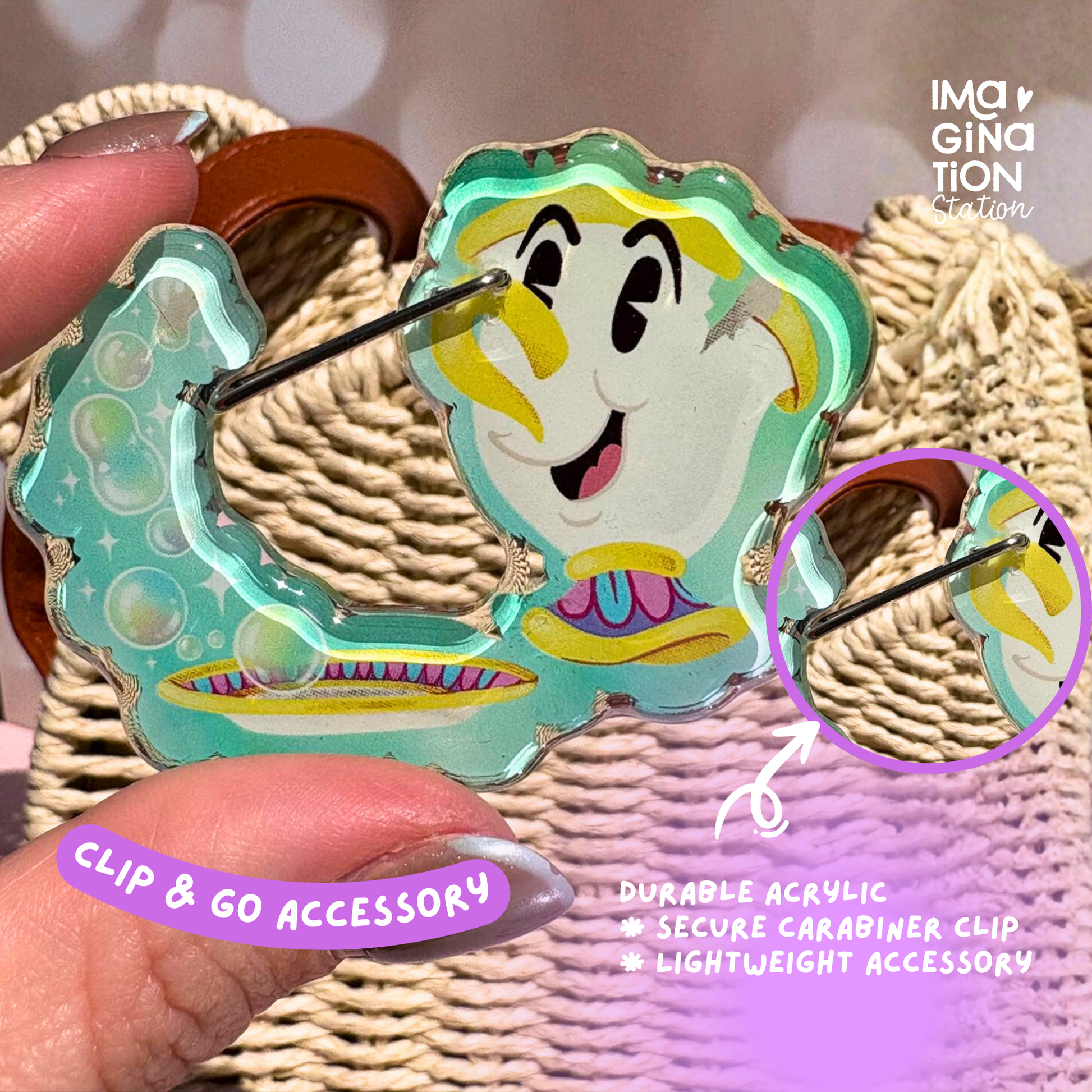 Colorful clip accessory with a cartoon character design held by a hand against a textured background.