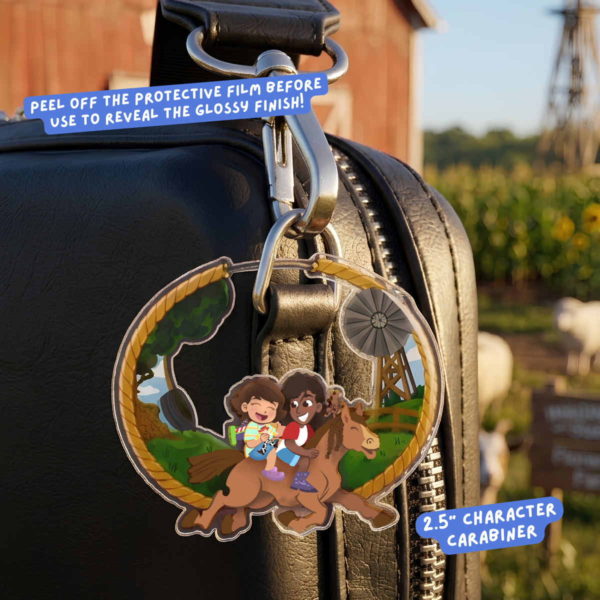 A circular character carabiner hanging from a black leather bag outdoors. The carabiner has a clear protective film being peeled off, revealing a glossy finish.
