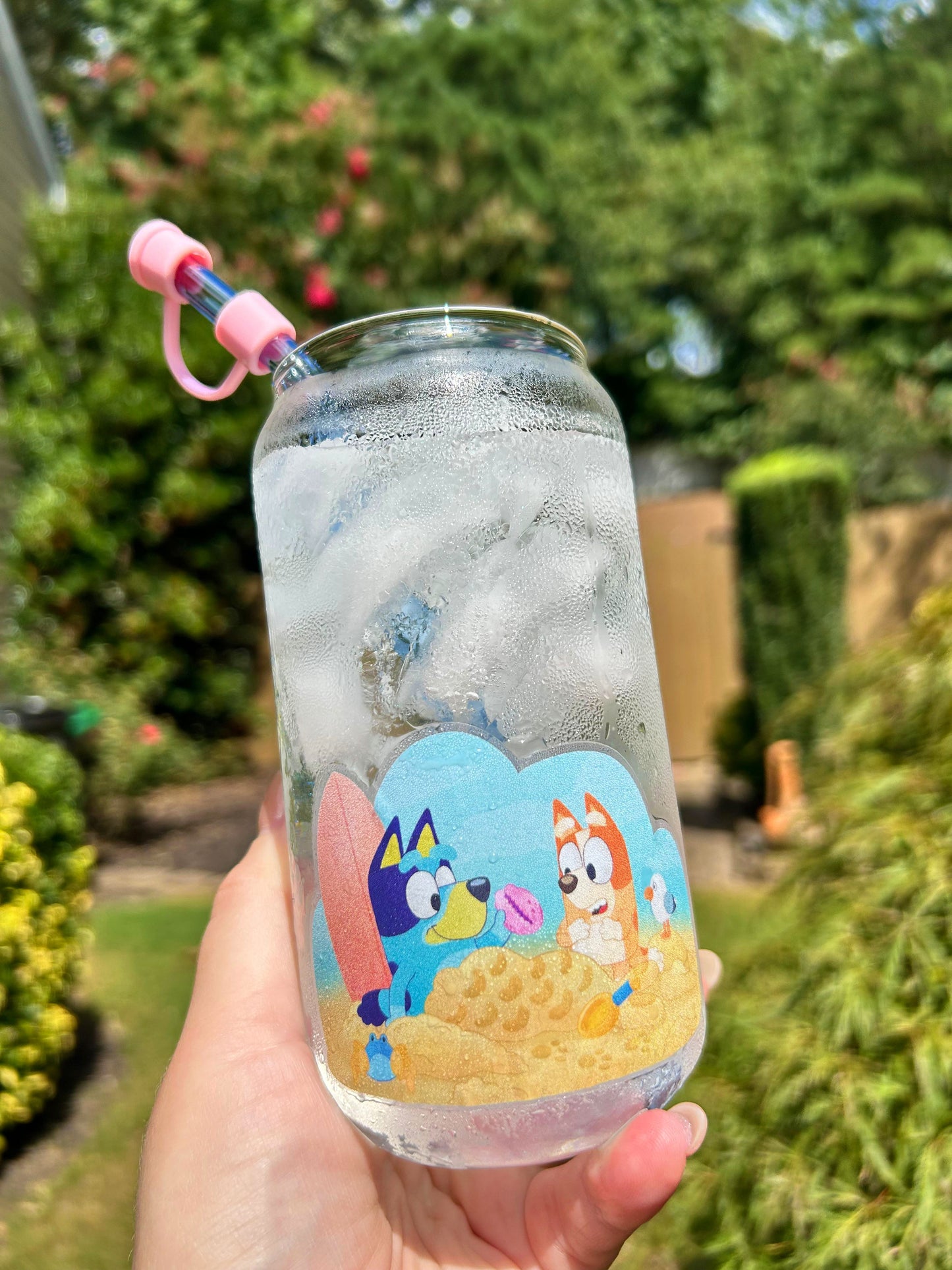 Bluey and Bingo beach day sticker held by hand – clear glossy Disney vinyl decal