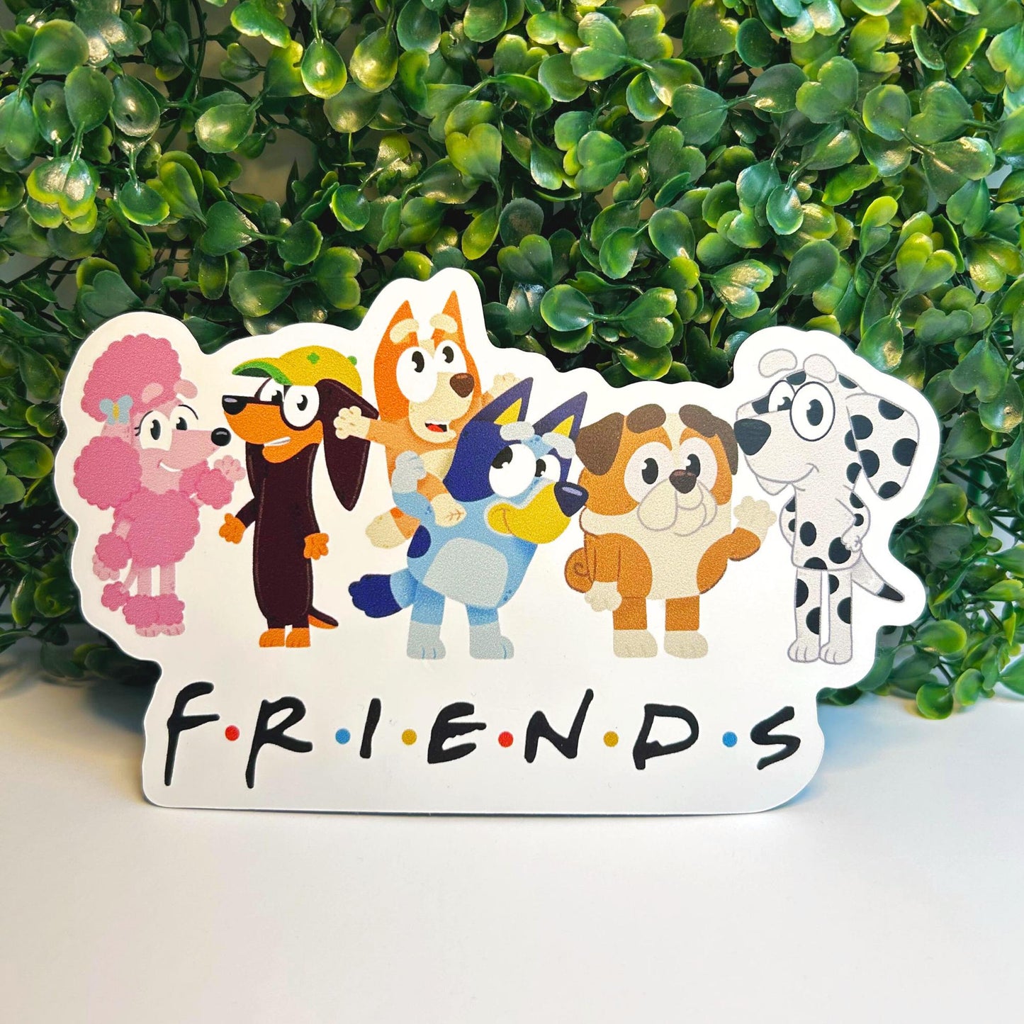 Cartoon dog characters with 'FRIENDS' text against a green leafy background