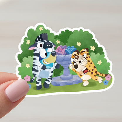 Sticker of a zebra and a tiger in a garden setting with 'Bluey and Bingo' text above.