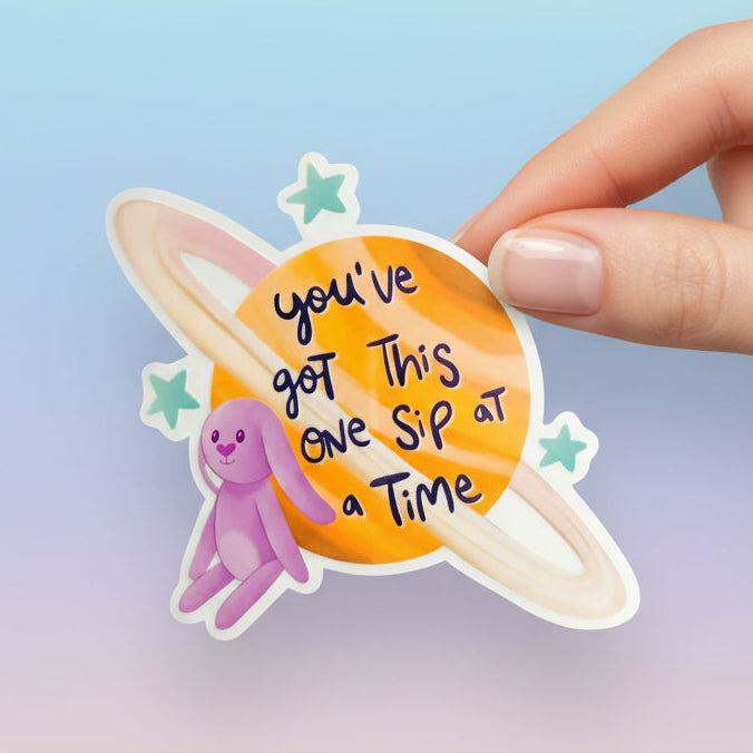 Sticker with text 'you've got this one sip at a time' and character, with 'Bluey Sticker' and 'Imagination Station' branding.