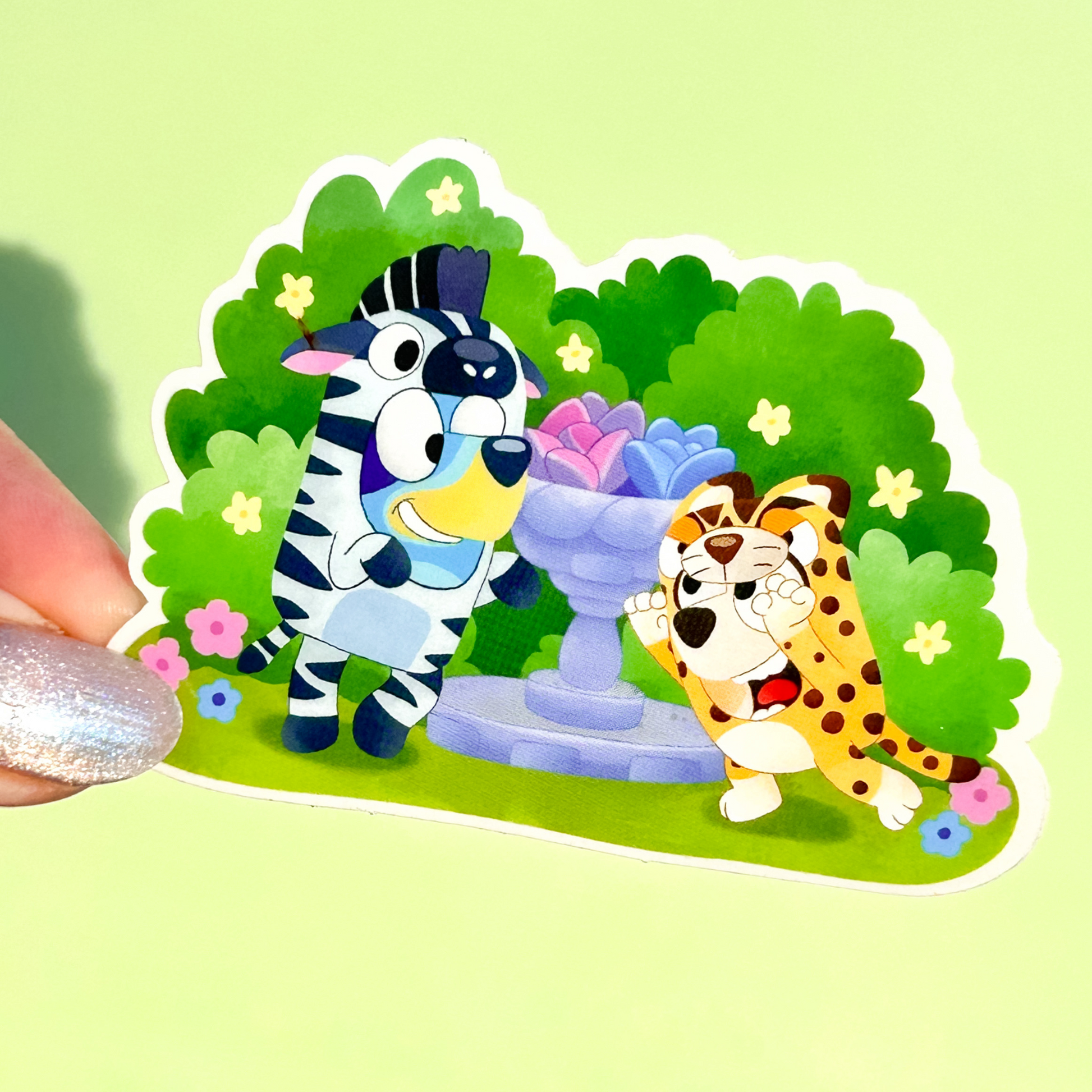 Bluey and Bingo onesies sticker held by hand – transparent glossy waterproof Disney vinyl