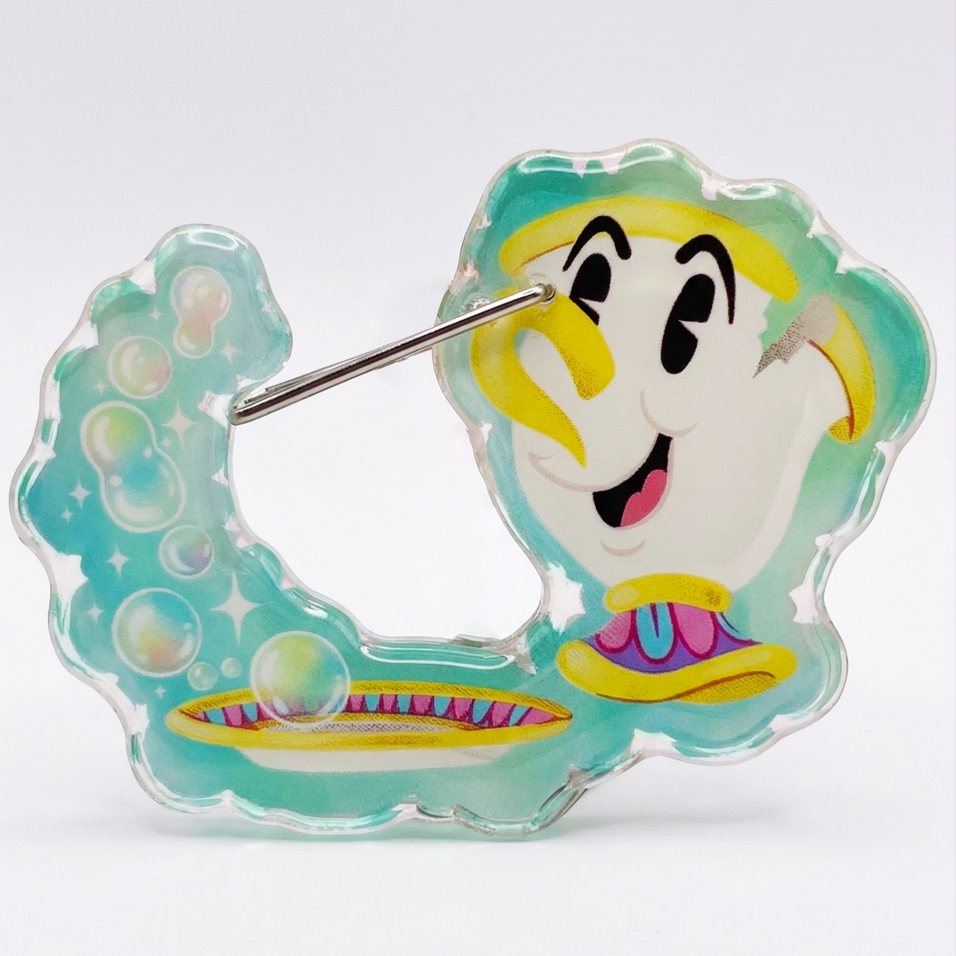 Cartoon character design on a clear plastic clip with a light blue background