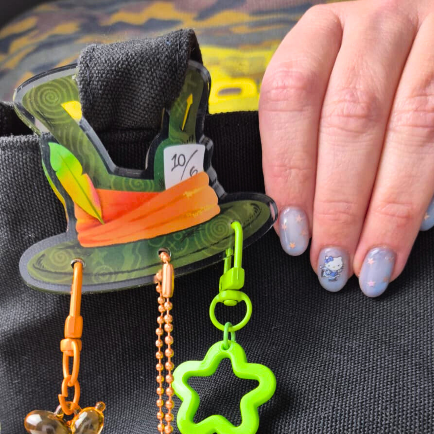 Mad Hatter Alice in Wonderland carabiner clip attached to backpack zipper