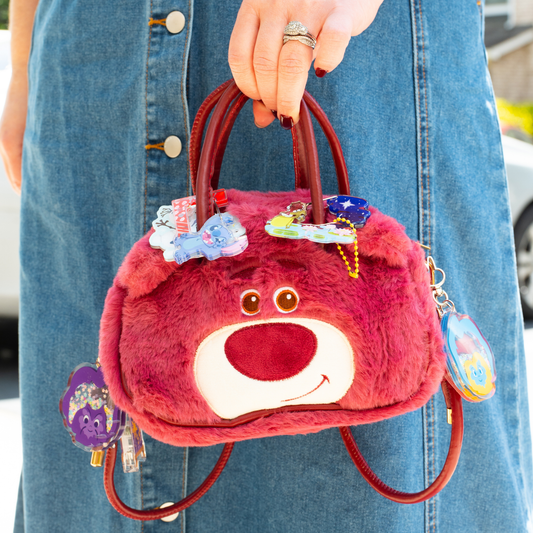 Lotso Bear plush crossbody bag front view – fuzzy pink Toy Story character purse with gold hardware