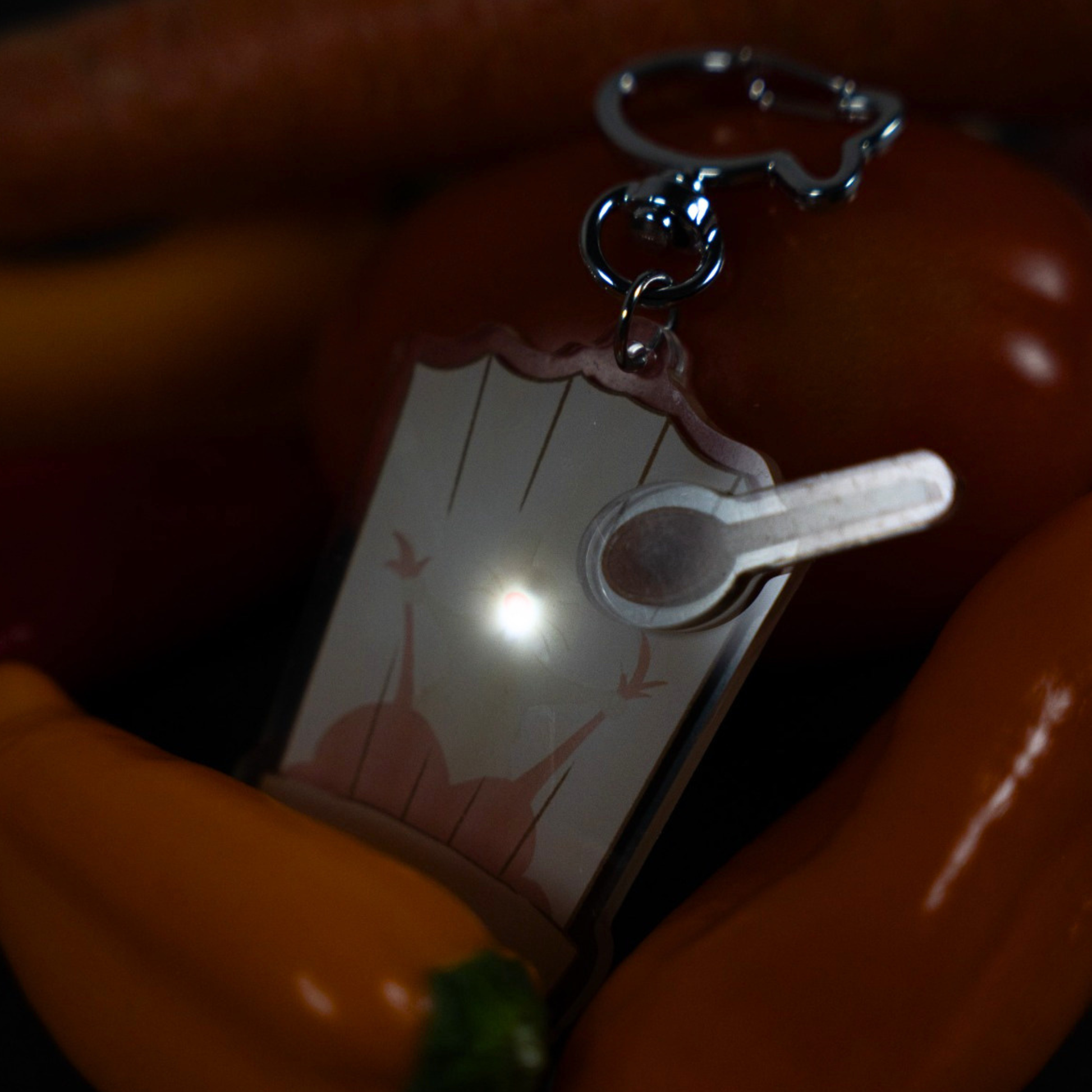 Remy Ratatouille keychain on orange background showing full chef hat shape