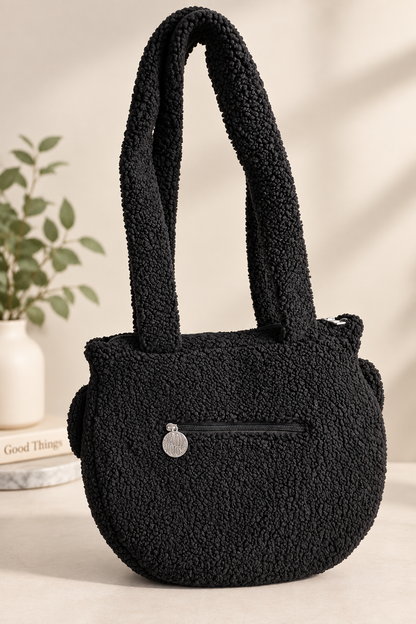 Cauldron crossbody bag styled on a shelf with fall decor