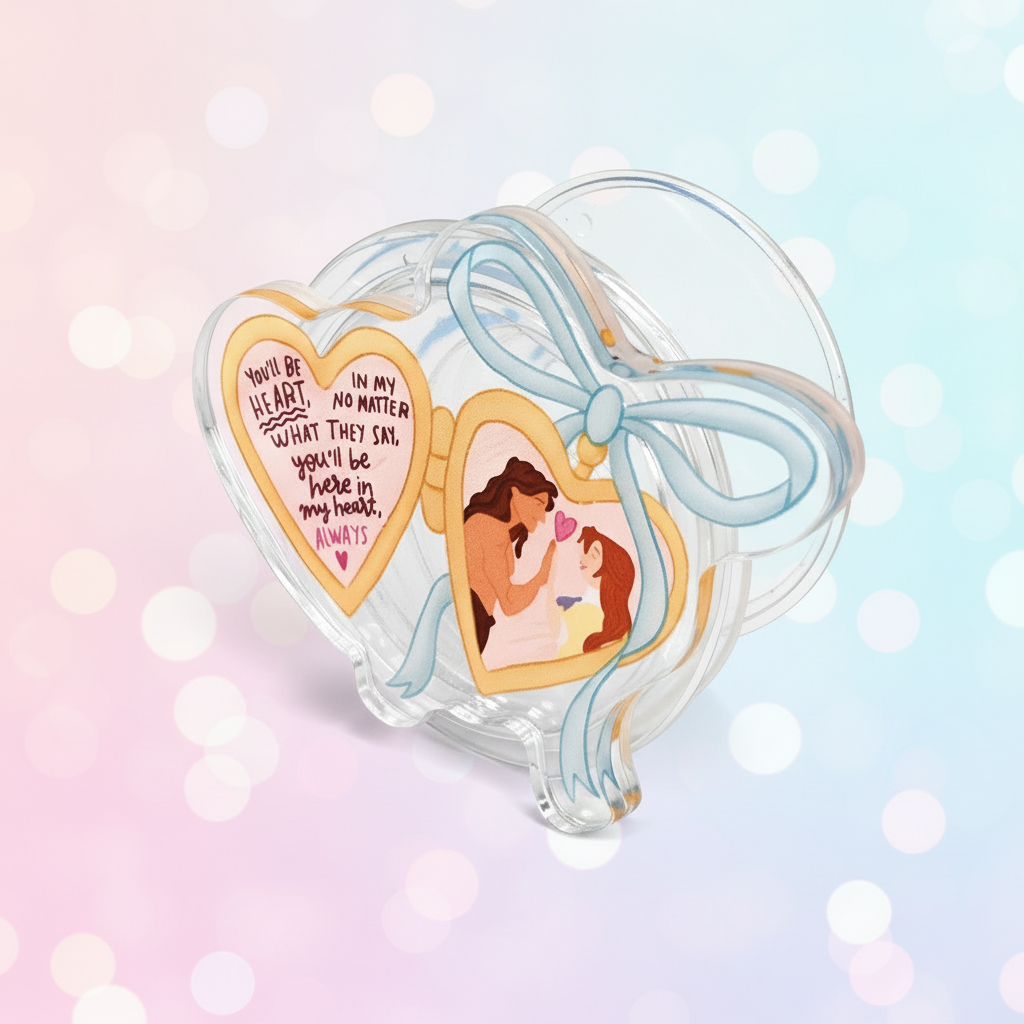 Heart-shaped phone holder with 'Tarzan & Jane' design on a pink background