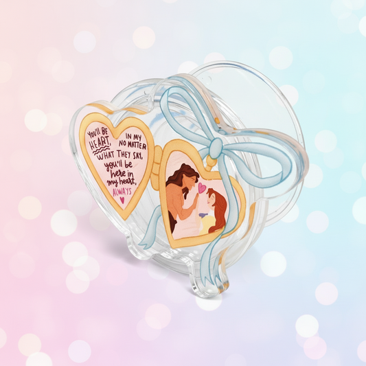 Heart-shaped phone holder with 'Tarzan & Jane' design on a pink background